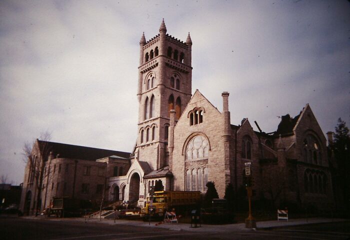 Majestic historic church with grand architecture and a tall bell tower under a cloudy sky, showcasing intricate stonework.