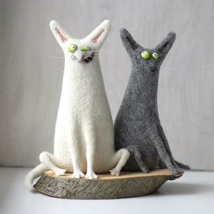 Strange art dolls of whimsical animal figures by a Georgian artist, featuring two peculiar felt cats with wide eyes.