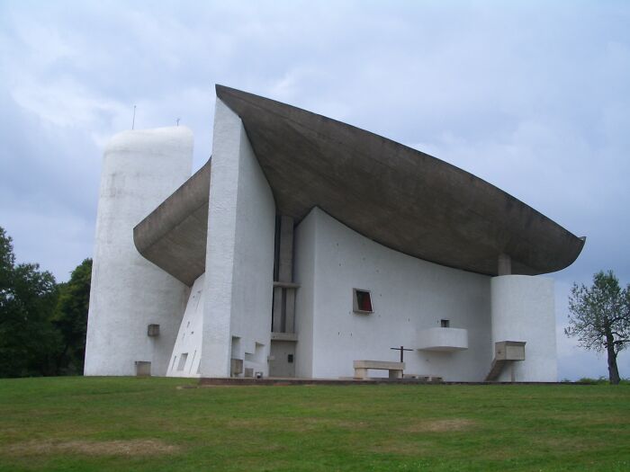 Modern architectural church with unique roof design on a cloudy day; fascinating church photos.