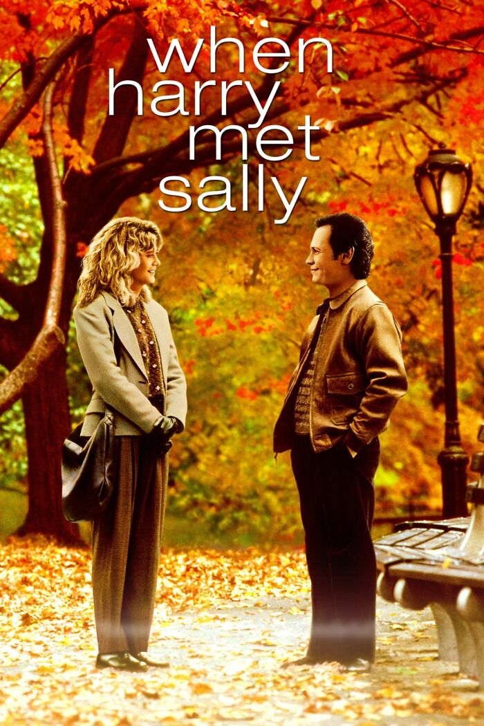 Scene from a Best Nostalgia Movie with two people standing in a park during fall, surrounded by colorful leaves.