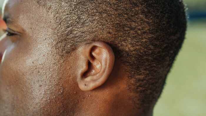 Close-up of a person's ear, showcasing detail, possibly related to unethical life hack discussions.