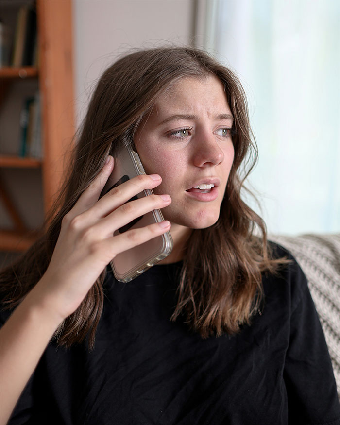 Woman on phone looking distressed, discussing betrayal and unwillingness to comfort ex-husband and friend after miscarriage.