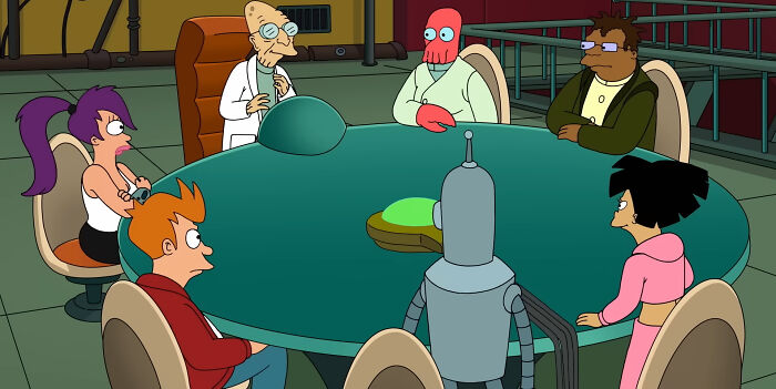 Animated characters from a beloved show sit around a green table in a futuristic setting.