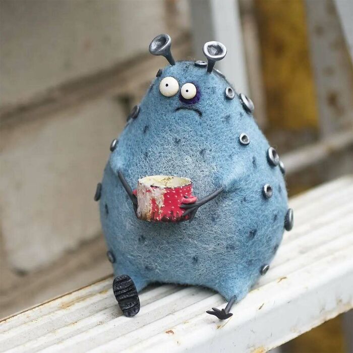 A funny-looking art doll resembling an animal, created by a Georgian artist, with antennae and a small red object.