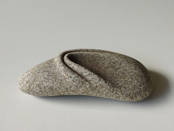 Stone sculpture appearing soft, defying physics with its realistic folds and textures.