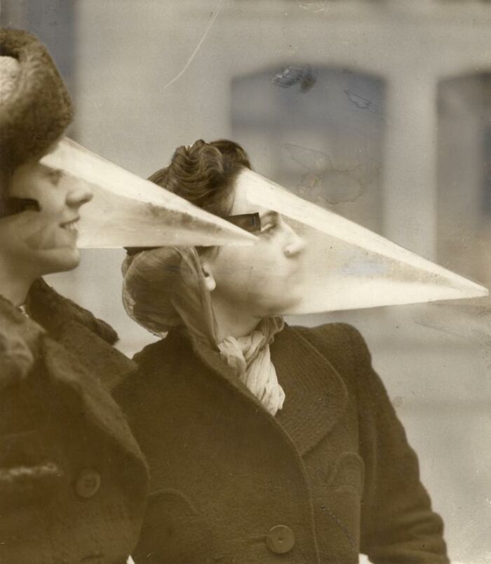 Women wearing cone-shaped protective face shields, an example of historical inventions ahead of their time.