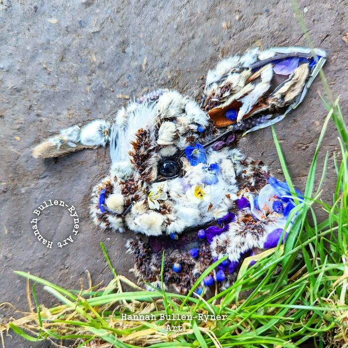 Animal portrait created using natural materials, featuring flowers and grass, as part of Earth art by a creative artist.