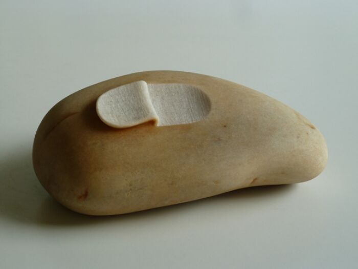 Stone sculpture resembling a soft pillow, showcasing art that defies physics.