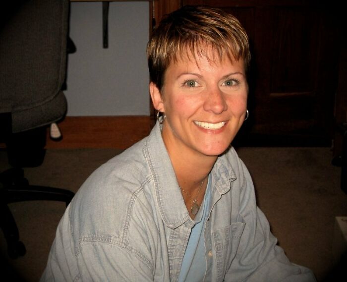 Smiling woman in casual attire indoors, related to true crime cases plot twists.