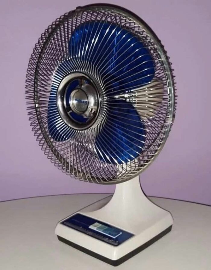 Vintage fan with blue blades on a table, representing nostalgic Gen X humor.