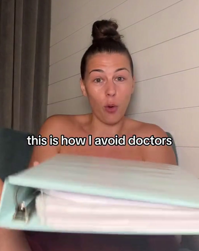 Woman showing her medical binder hack to ensure doctors take her seriously.