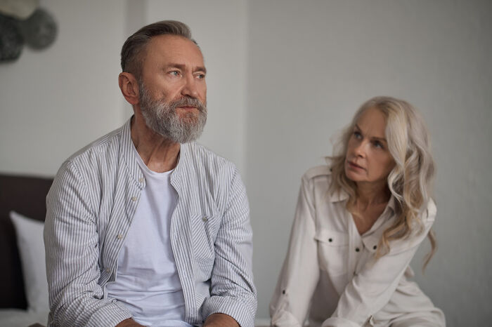 Older couple in a contemplative conversation, connected to realization of past issues.