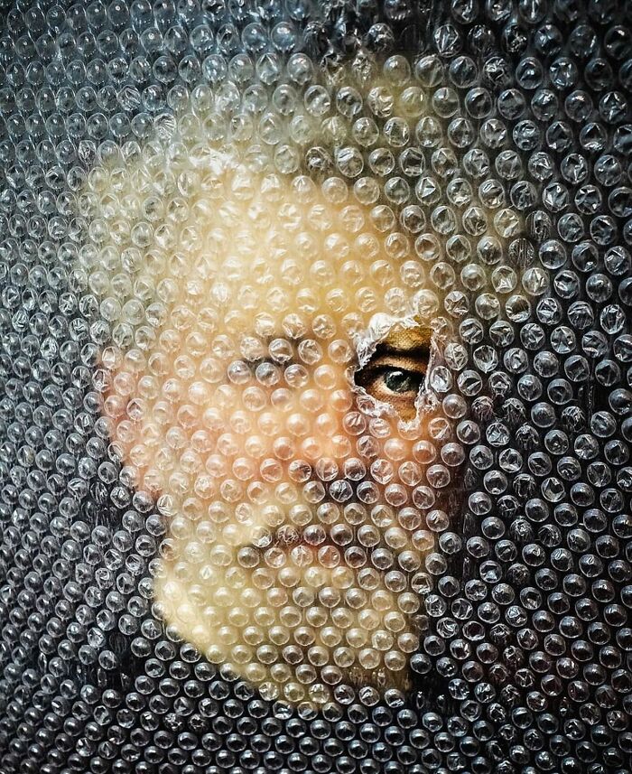 A face partially visible through bubble wrap in a creative and interesting image.