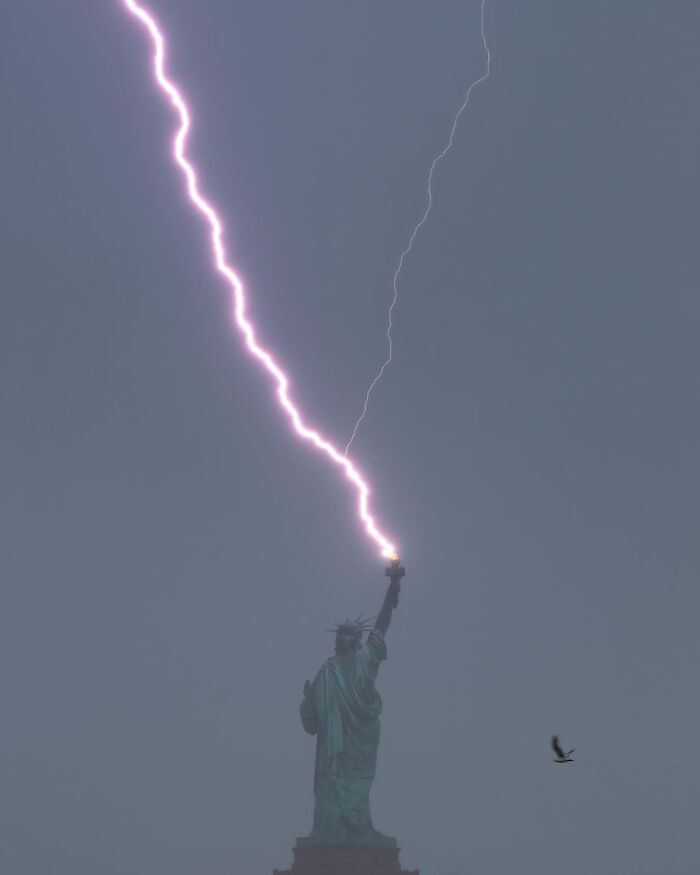 Lightning striking the Statue of Liberty torch, captured in an interesting image.