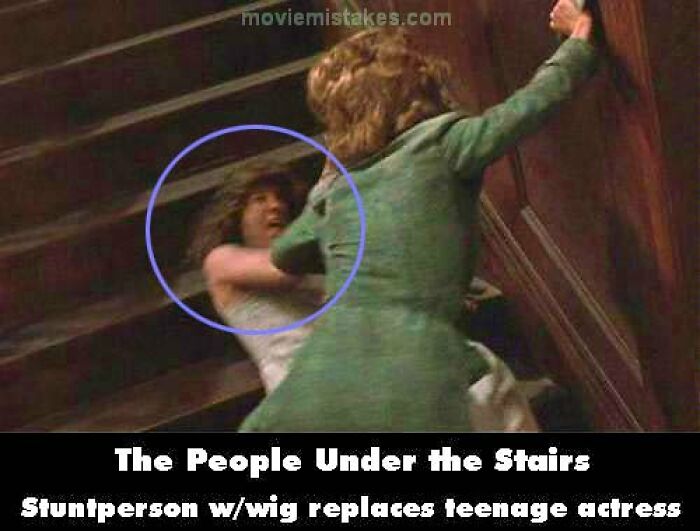 Stuntperson with wig noticeable in scene from "The People Under the Stairs" highlighting movie mistakes.