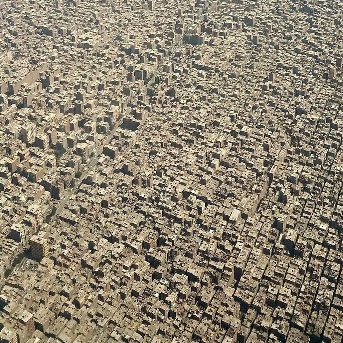 Aerial view of densely packed urban buildings creating an overwhelming urban hellscape.