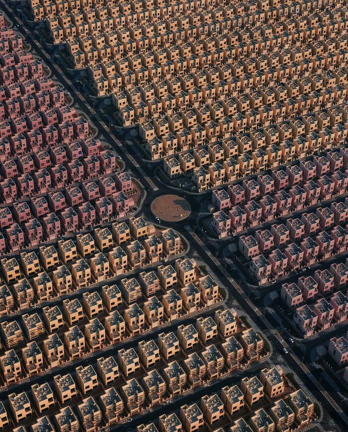 Aerial view of densely packed, uniform urban housing, illustrating an urban hellscape.