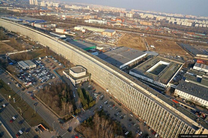 Aerial view of a massive, monotonous urban building complex, exemplifying 'urban hell' amidst an industrial landscape.