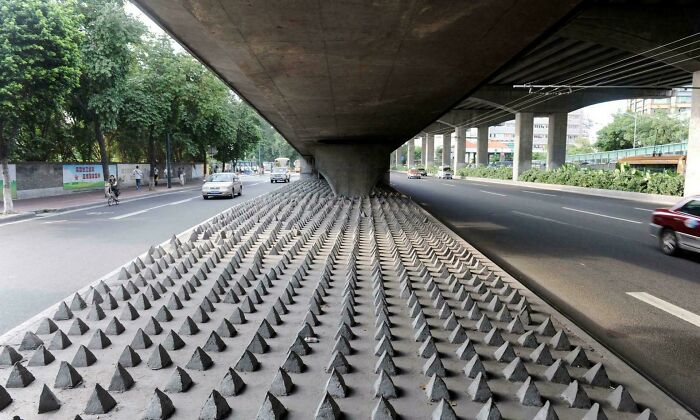 Spiked pattern under a city bridge illustrating a surreal urban hell scenario.