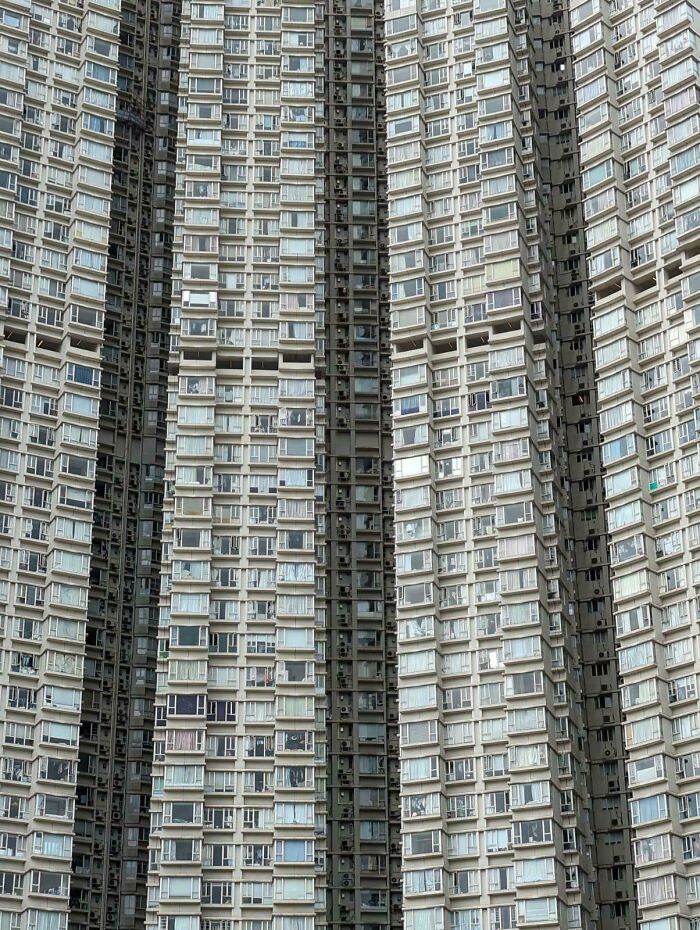 Dense urban apartments showcasing a massive cluster of identical high-rise buildings, reflecting an urban hellscape.