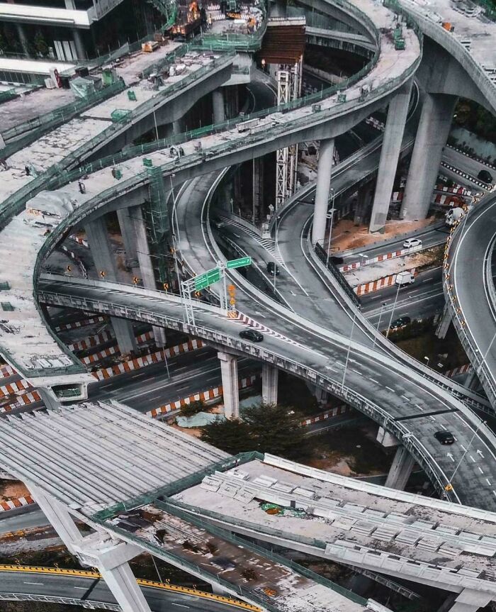 Complex urban hell highway interchange with multiple levels and curves, showcasing chaotic city infrastructure.