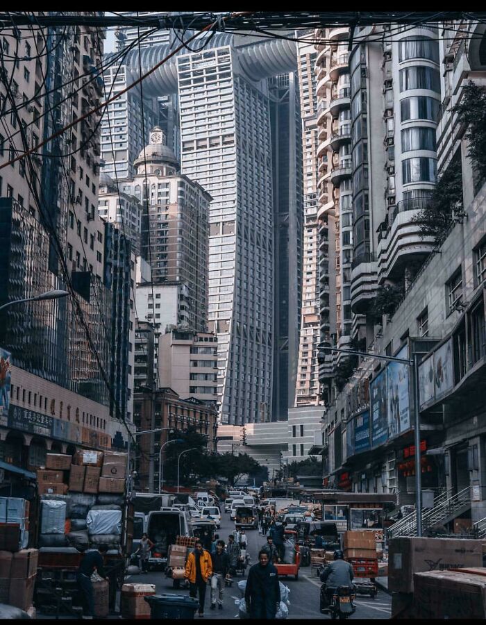 Urban hell scene with congested street, towering buildings, and dense traffic creating a chaotic atmosphere.