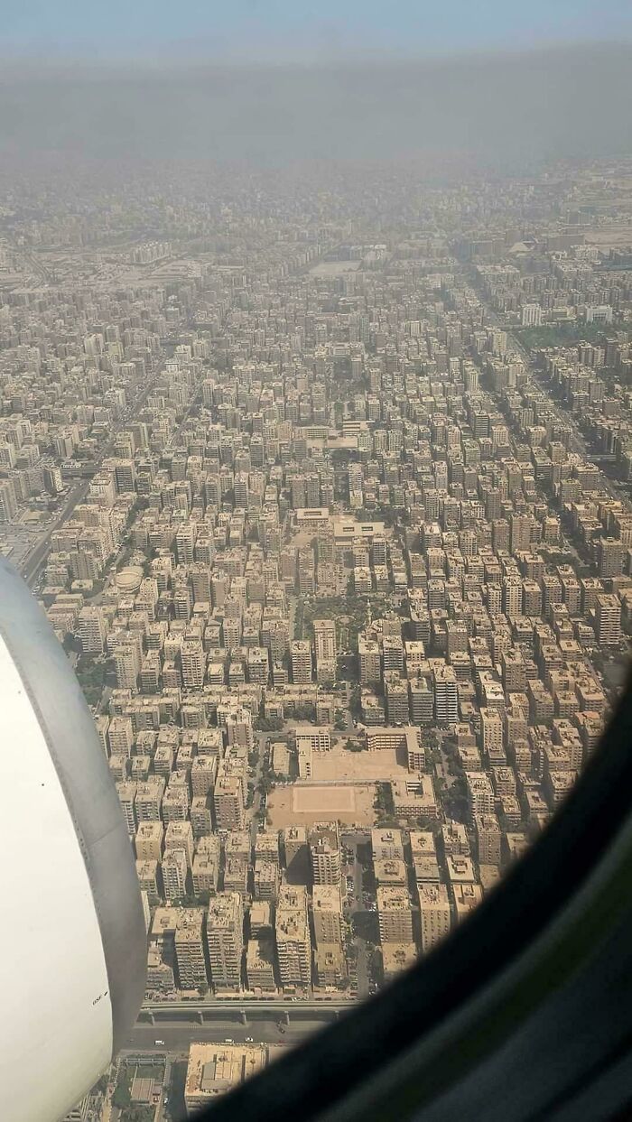 Aerial view of densely packed city buildings, exemplifying urban hell with overwhelming concrete structures.