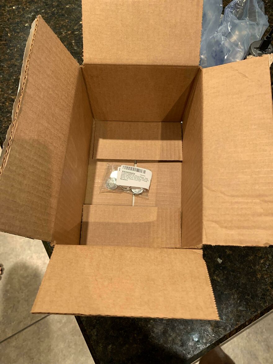 Large box with tiny item inside, illustrating wasteful packaging.