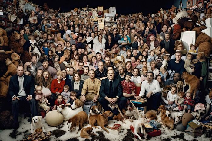 A large group of people and dogs in a cluttered room, illustrating the symphonic chaos of modernity.