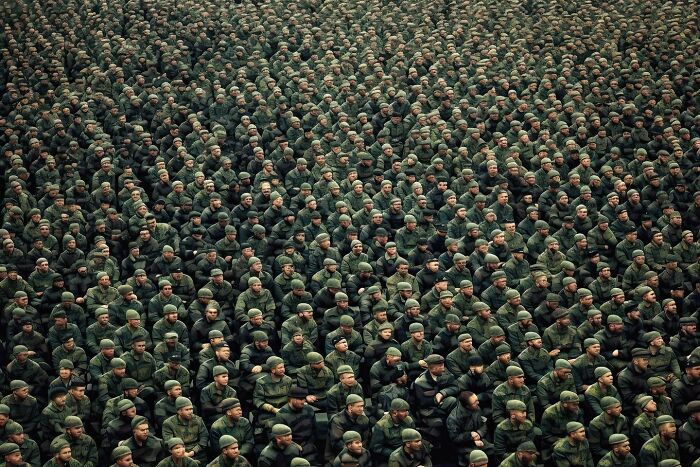 A vast crowd of soldiers in uniform, symbolizing the symphonic chaos of modernity.