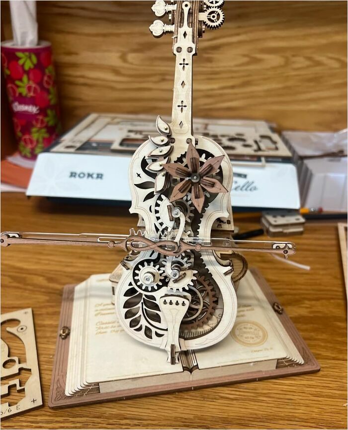 Wooden mechanical violin model on a table, representing new hobbies for 2025.