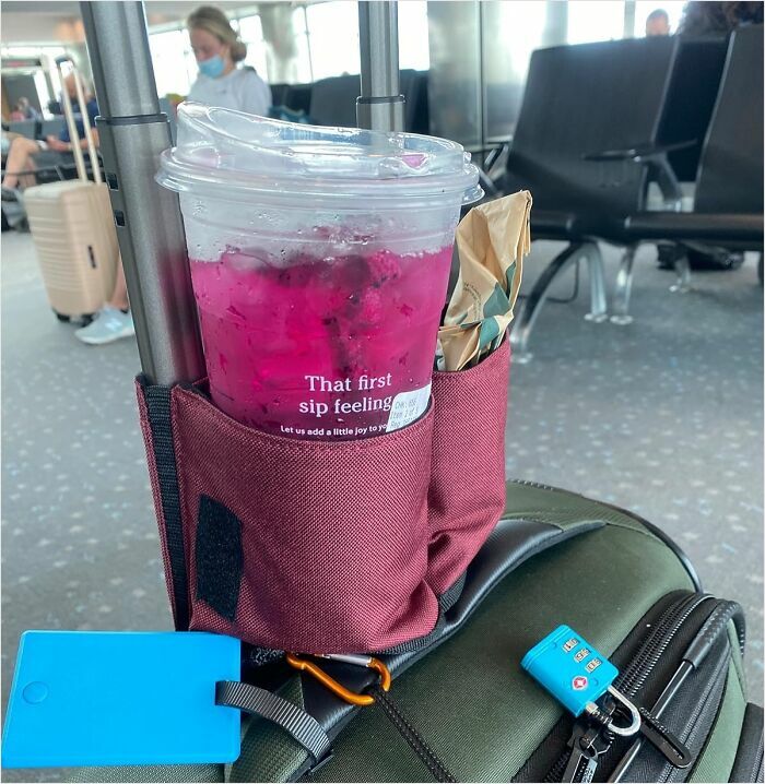 Travel smart with a drink holder attached to a suitcase at the airport, enhancing your vacation experience.