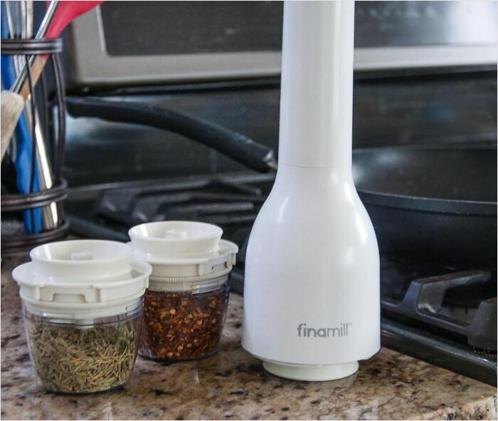 Finamill spice grinder with filled spice pods on a kitchen counter for small life upgrades.