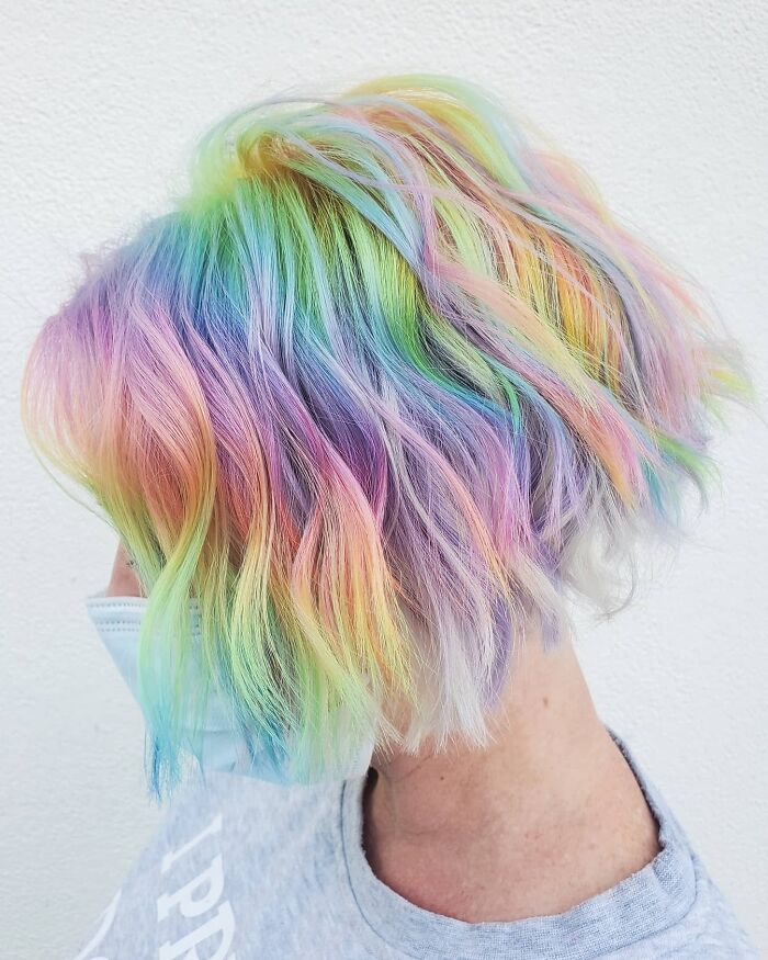 Vibrant rainbow bob showcasing changing hair color in a stylish, colorful transformation.