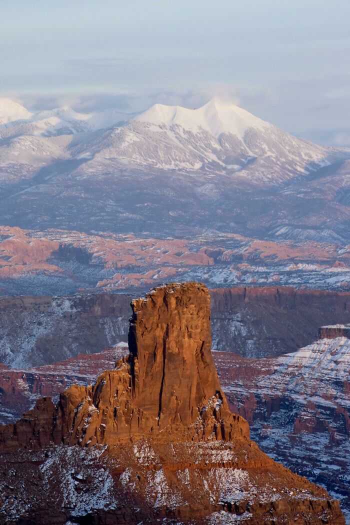 Rocky landscape with snowy mountains in the background, showcasing Incredible-World-Photos scenery.