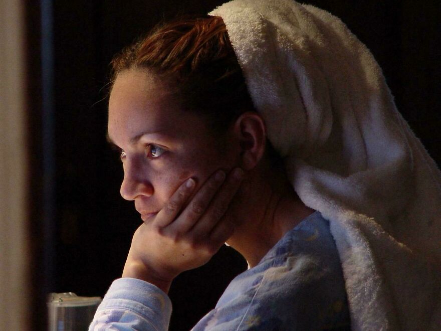 Woman with a towel on her head, sitting in contemplative thought; represents accidental art in everyday life.