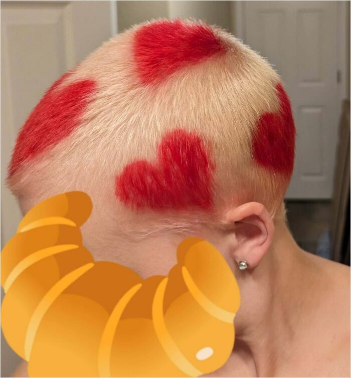 Blonde hair with red heart-shaped designs, showcasing creative changing hair color.