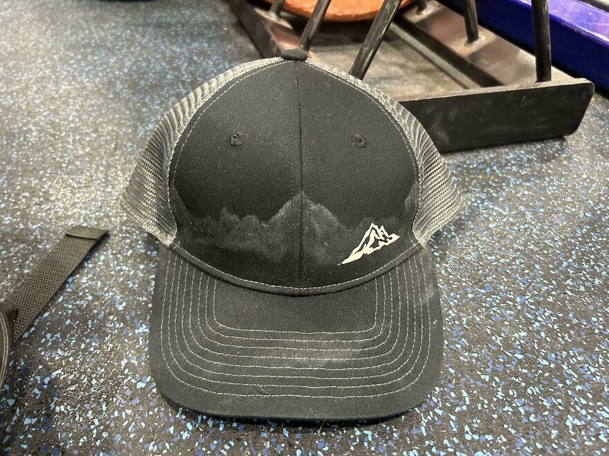 Cap with mountain design and sweat stain resembling a mountain range, illustrating things looking like other things.