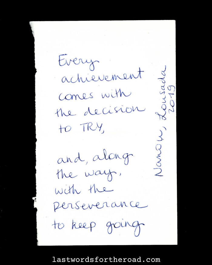 Inspirational quote handwritten on a card about achievement, trying, and perseverance.