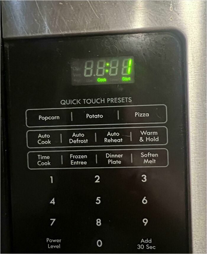 Microwave with unreadable display, illustrating common horrible roommates' habits with appliances.