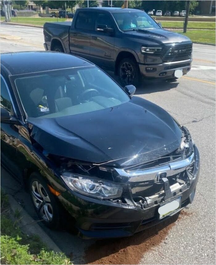 Damaged car parked on the street, highlighting a stressful aspect of horrible roommates.