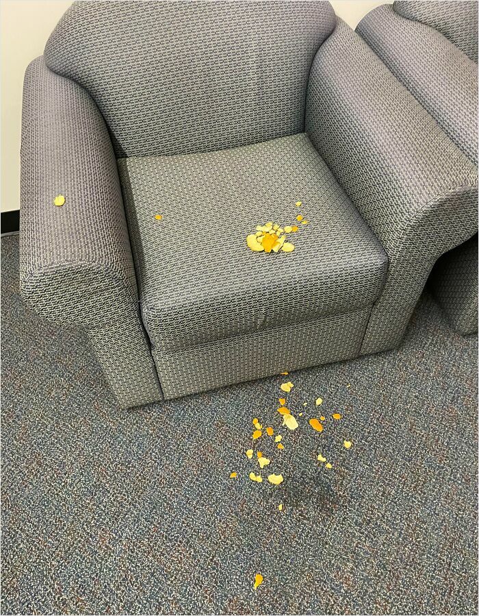 Crumbs scattered on a sofa and carpet, showing messy habits of horrible roommates.