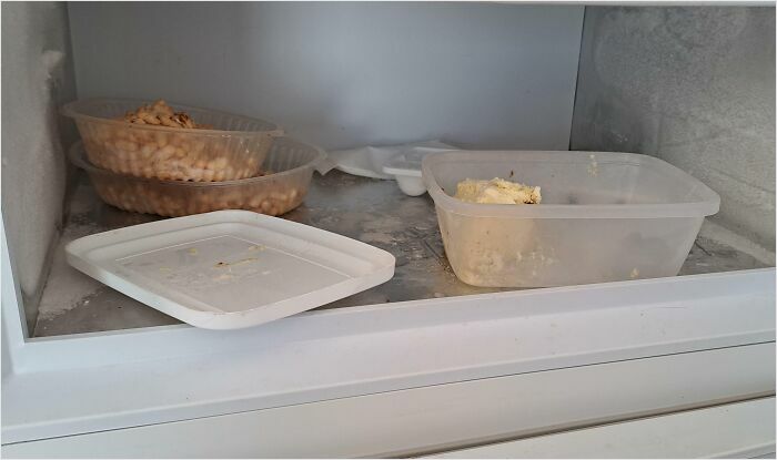 Messy fridge shelf with open food containers, illustrating habits of horrible roommates.