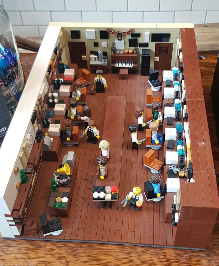 Cool LEGO builds depicting a busy office scene with mini-figures, desks, and computers in an intricate design.