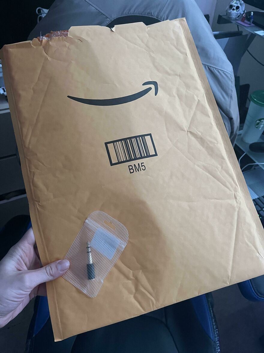 Large envelope with unnecessary packaging for a small item, highlighting wasteful practices.