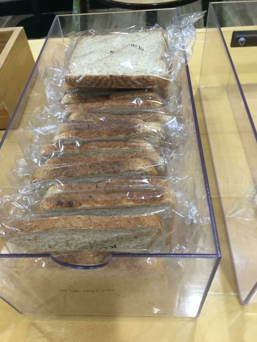 Slices of bread individually wrapped in plastic, highlighting wasteful, unnecessary packaging.