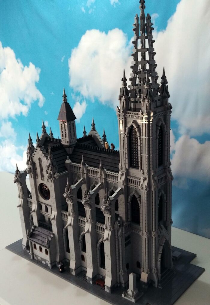 Gothic cathedral built from LEGO bricks against a cloudy sky background.