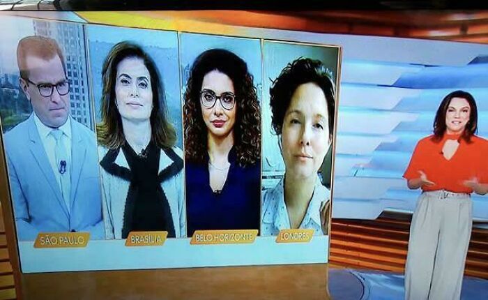 TV screen displays four people from different cities creating confusing perspective.