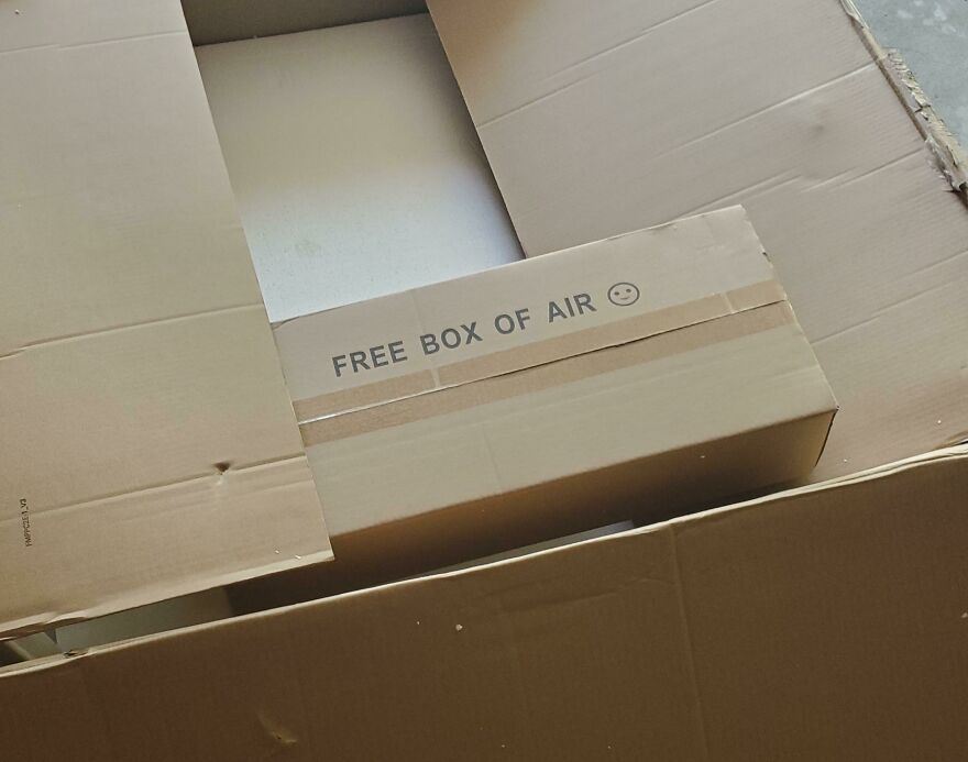 Large empty box with smaller box labeled "Free Box of Air," illustrating wasteful packaging.