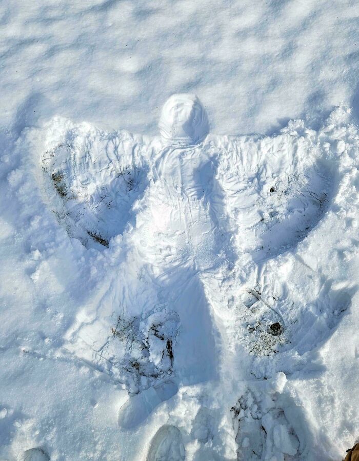 Snow angel impression on fresh snow, creating a confusing perspective.